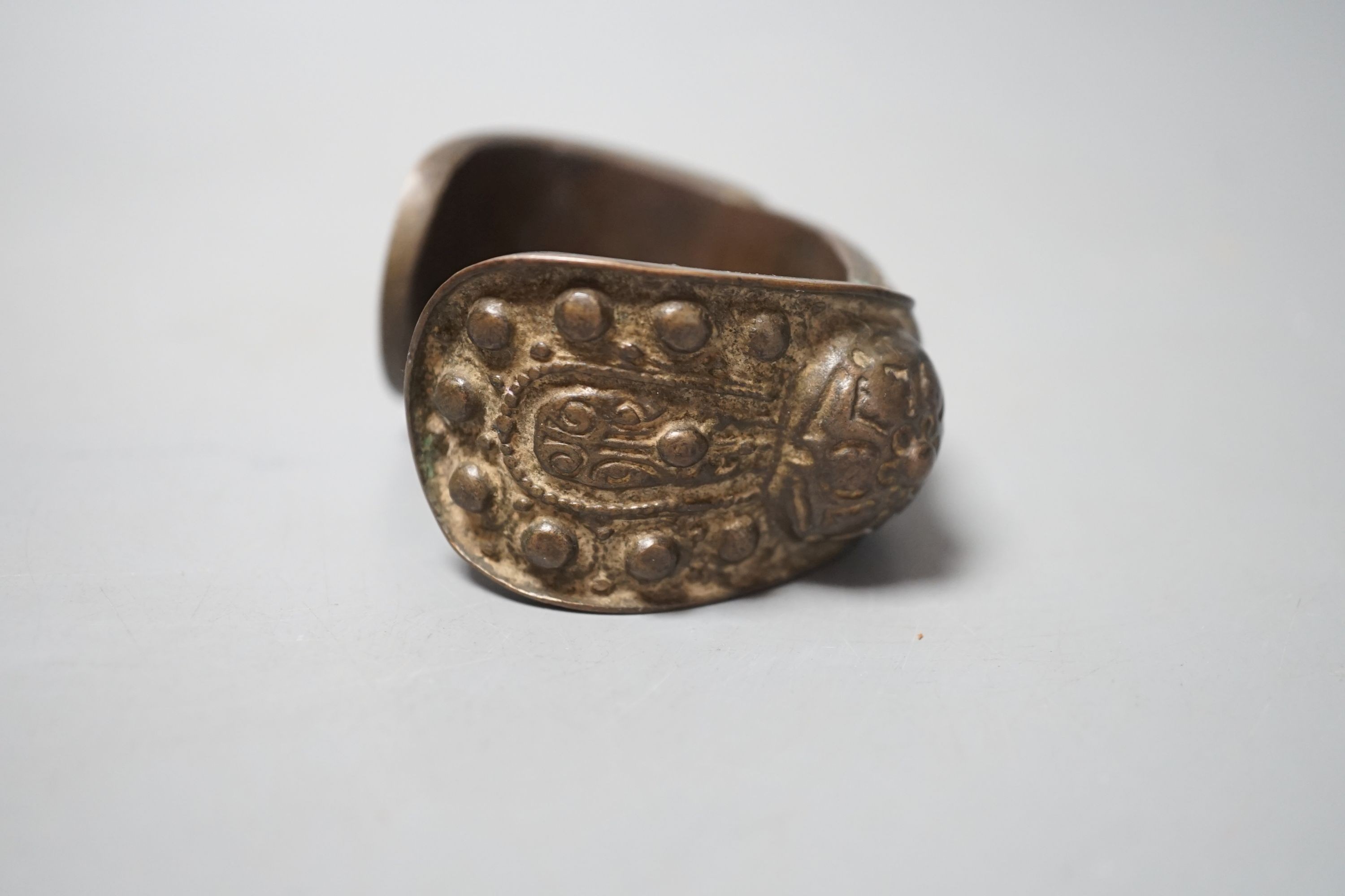 A Chinese brass bangle